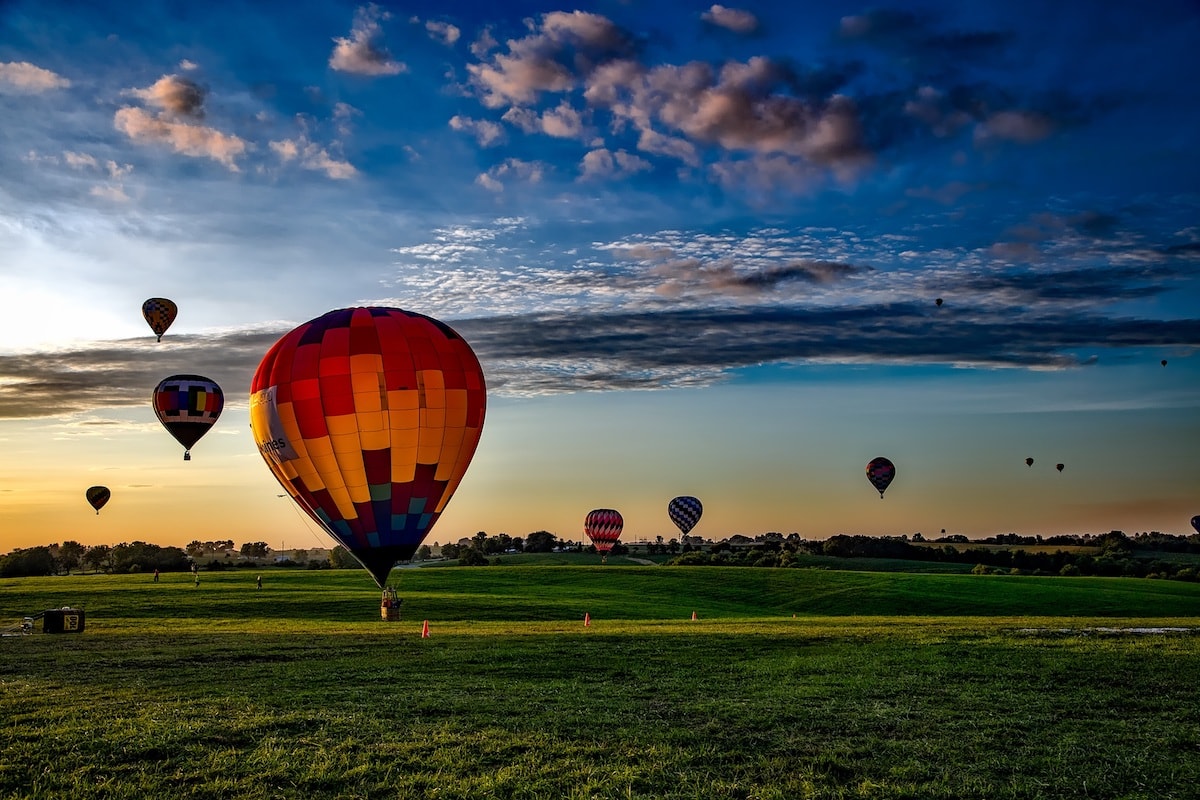 hot air balloons taking off at sunrise